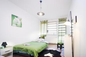 a bedroom with a green bed and a desk at Apartment 10 Visoko in Visoko
