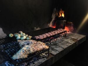 a grill that has a bunch of food on it at 531 Hostel in Córdoba