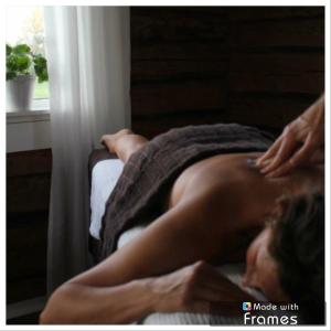 a woman laying on a bed in a towel at Lavendeltorpet in Häggum
