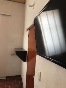 a refrigerator with a television on top of it at Hostal Rous San Gil in San Gil