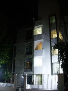 a tall white building with lights on it at night at Villa Antilope in Cancún