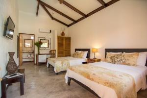 Uma cama ou camas num quarto em Conchal Hotel