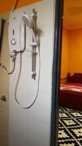 a shower in a bathroom with a shower head at Homestay Koperasi Surau Alfalah in Semporna +104 photos