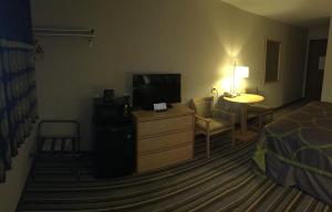 a hotel room with a bed and a television at Super 8 by Wyndham Dillon in Dillon