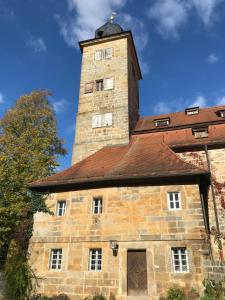 an old stone building with a tower on top at Landhaus Schönfelder Hof in Hollfeld +13 photos