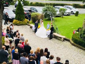 a bride and groom walking down the aisle at their wedding at Landhaus Schönfelder Hof in Hollfeld