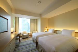 A bed or beds in a room at Nagoya JR Gate Tower Hotel
