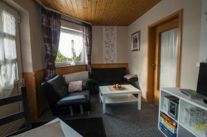 a living room with a couch and a table at Ferienappartement Persang GbR in Eppenbrunn