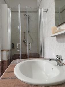 a bathroom with a sink and a shower at B&B Gassa d'Amante in Capoterra