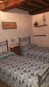מיטה או מיטות בחדר ב-Casa Costanza