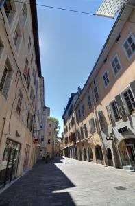 an empty street in a city with buildings at Les Petits Boudoirs de Savoie in Chambéry