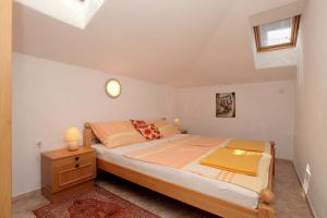 a bedroom with a bed and a dresser and a window at Vila Nataly in Trogir