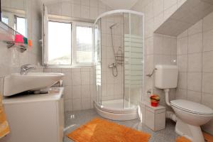 a bathroom with a shower toilet and a sink at Vila Nataly in Trogir +29 photos