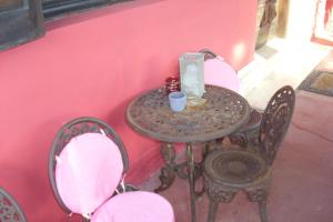a table with two chairs and a table with a cup on it at Art House in Pandokrátor