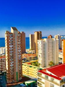 a city skyline with tall buildings and the ocean at Piscis Of The Sea Benidorm in Benidorm +58 photos