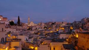 a view of a city at night at L'eco dei sassi in Matera