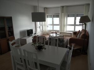 a living room with a white table and chairs at Lila's Beach Apartment in São Roque