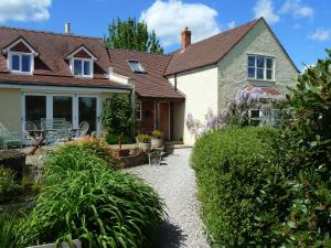 a house with a gravel path in front of it at The Lodge, at Orchard Cottage in Much Marcle