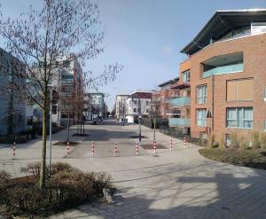 a street with red and white poles in a city at Aaron - Privatunterkunft in Magdeburg