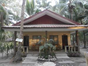 a small house with a roof at Adventure Camp Beach Resort in Sablayan