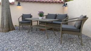 a table and two chairs and a table with flowers on it at Terra Rossa in Loborika