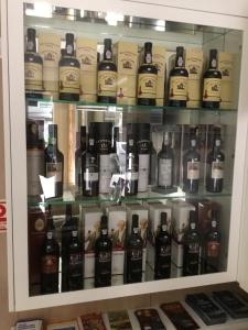 a display case filled with bottles of wine at Seculo Hotel in Porto