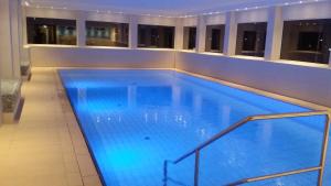 a large swimming pool with blue lighting in a building at Terrassenhaus Penthouse-Wohnung 93 in Cuxhaven