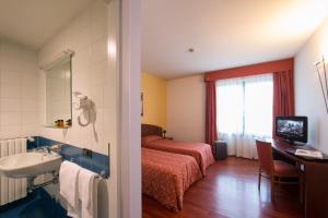 Voodi või voodid majutusasutuse Hotel La Cascata toas