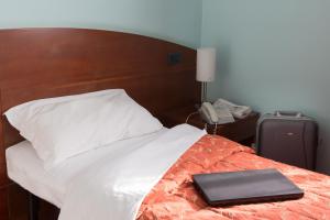 Voodi või voodid majutusasutuse Hotel La Cascata toas