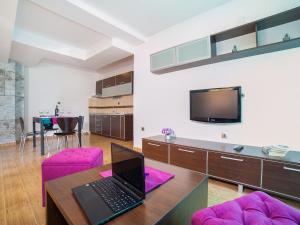 a living room with a laptop on a table at Apartments Raymond in Sveti Stefan