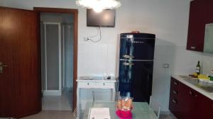 a kitchen with a refrigerator and a table in it at Cà di Boschetti Old Farm f in La Spezia +31 photos