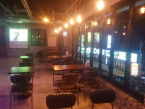 a room with tables and chairs and a screen at K Guesthouse in Gangneung