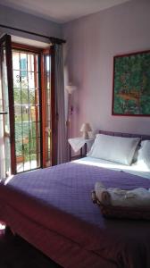 a bedroom with a large bed and a window at Al Giardino Di Alice in Perugia