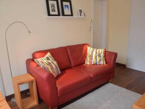 バンシンにあるRolandseck I Whg 07のリビングルーム(赤い革張りのソファ、枕2つ付)