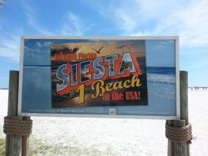 a sign for a beach in the usa at 2BR/1BA Sienna Park Apartment in Sarasota