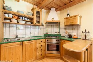 a kitchen with wooden cabinets and green counter tops at Chalet Klara in Resnik