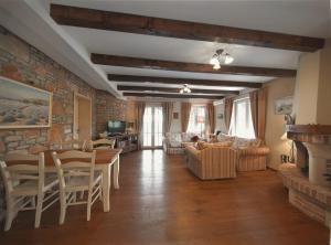 a living room filled with furniture and a brick wall at Villa Rosa in Vrboska