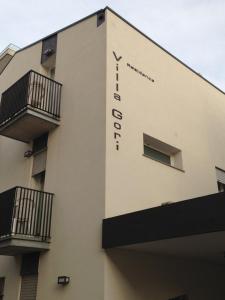 a building with a sign on the side of it at Residence Villa Gori in Rimini