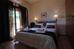 a bedroom with a large bed with towels on it at La C Mer in Larnaca