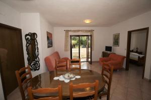 a dining room with a table and chairs at Villa Linet Garden in Funtana