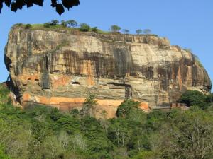 a large rock with a house on it at Purasanda Villa in Sigiriya