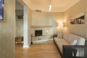 a living room with a couch and a fireplace at Allika Apartments in Tallinn