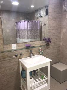 a bathroom with a sink and a shower at Fragancias Serranas in Cortaderas