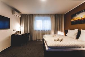 Postel nebo postele na pokoji v ubytování SILESIA Residence