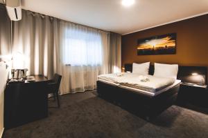 Postel nebo postele na pokoji v ubytování SILESIA Residence