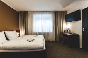 Postel nebo postele na pokoji v ubytování SILESIA Residence