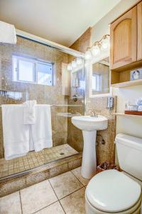 a bathroom with a shower and a toilet and a sink at The Inn at Sunset Cliffs in San Diego