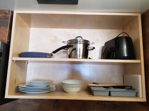 a shelf with plates and bowls and a tea pot at Days Inn by Wyndham Golden in Golden