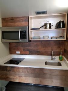 a kitchen with a sink and a microwave at Days Inn by Wyndham Golden in Golden