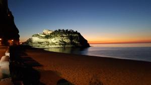 a beach with a castle on top of a mountain at Borgo di Santa Barbara in Santa Domenica